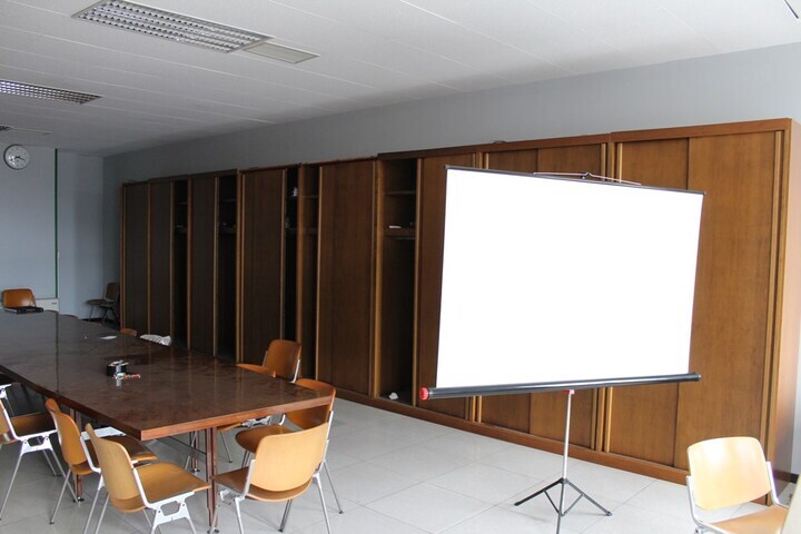 Contents of Boardroom to include Conference Table with (20) x Chairs, Projection Screen, Flip Chart & Cupboard Units